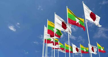 Myanmar, Burma and Japan Flags Waving Together in the Sky, Seamless Loop in Wind, Space on Left Side for Design or Information, 3D Rendering video