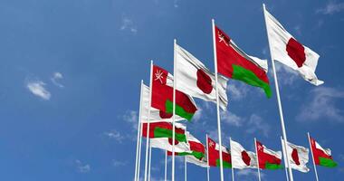 Oman and Japan Flags Waving Together in the Sky, Seamless Loop in Wind, Space on Left Side for Design or Information, 3D Rendering video