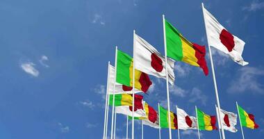 Mali and Japan Flags Waving Together in the Sky, Seamless Loop in Wind, Space on Left Side for Design or Information, 3D Rendering video