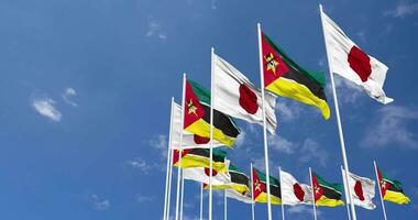 Mozambique and Japan Flags Waving Together in the Sky, Seamless Loop in Wind, Space on Left Side for Design or Information, 3D Rendering video