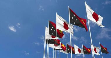 Papua New Guinea and Japan Flags Waving Together in the Sky, Seamless Loop in Wind, Space on Left Side for Design or Information, 3D Rendering video