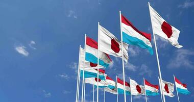 Luxembourg and Japan Flags Waving Together in the Sky, Seamless Loop in Wind, Space on Left Side for Design or Information, 3D Rendering video