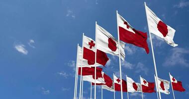 Tonga and Japan Flags Waving Together in the Sky, Seamless Loop in Wind, Space on Left Side for Design or Information, 3D Rendering video