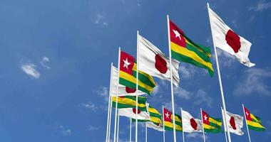 Togo and Japan Flags Waving Together in the Sky, Seamless Loop in Wind, Space on Left Side for Design or Information, 3D Rendering video