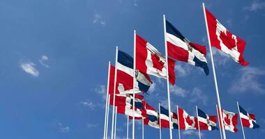 Dominican Republic and Canada Flags Waving Together in the Sky, Seamless Loop in Wind, Space on Left Side for Design or Information, 3D Rendering video