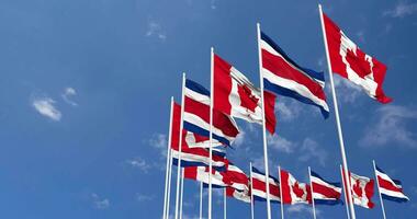 Costa Rica and Canada Flags Waving Together in the Sky, Seamless Loop in Wind, Space on Left Side for Design or Information, 3D Rendering video