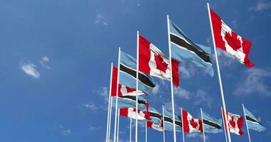 Botswana and Canada Flags Waving Together in the Sky, Seamless Loop in Wind, Space on Left Side for Design or Information, 3D Rendering video