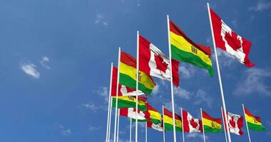 Bolivia en Canada vlaggen golvend samen in de lucht, naadloos lus in wind, ruimte Aan links kant voor ontwerp of informatie, 3d renderen video