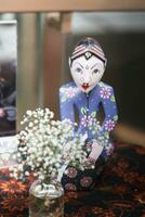 Javanese traditional doll sitting on the altar photo