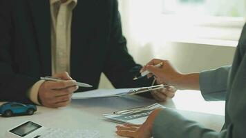 Insurance officers hand over the car keys after the tenant. have signed an auto insurance document or a lease or agreement document Buying or selling a new or used car with a car video