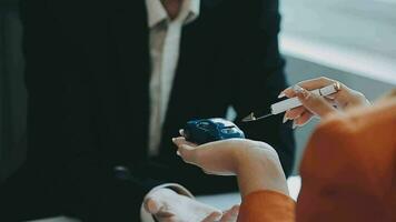 Salesman guiding customer seated at table Car business Dealership closing. and the new owner has entered into a contract video