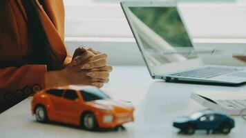 Salesman guiding customer seated at table Car business Dealership closing. and the new owner has entered into a contract video