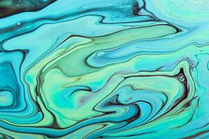 Fluid Art. Abstract marble background or texture. Beautiful blue and green waves with black veins and gold particles photo