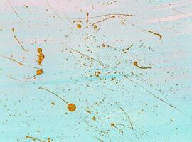 Gold splashes of different shapes on pastel background. Hand painted background or texture for your design photo
