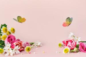 Beautiful spring and summer flowers and butterflies on pink background. Spring Easter or summer holiday background photo