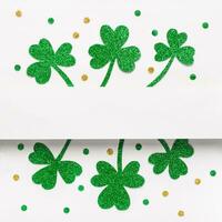 Green glitter shamrocks and confetti pattern background. Elegant St. Patricks Day background photo