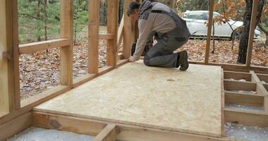 Man worker building wooden frame house. Carpentry concept. video