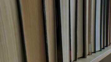 Book shelf's in library. Close up Many books organized in shelves in a big bookstore. The concept of learning, reading, and knowledge. video