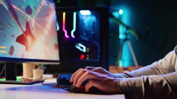 Man using gaming RGB lit mouse to shoot asteroids in spaceship flying videogame. Gamer using powerful PC and computer peripherals to compete in science fiction multiplayer game video