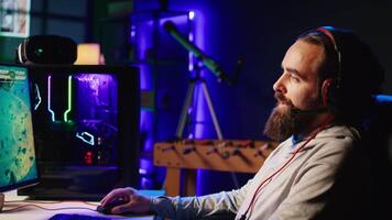 Zoom in on man discussing with friends online while playing singleplayer videogame with spaceship shooting at asteroids. Close up of gamer chatting with teammates while hitting targets in SF game video