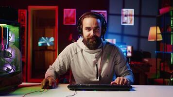 Esports player recording himself playing videogames in front of online viewers during livestream, providing engaging commentary while battling foes. Pro gamer streaming gaming session video