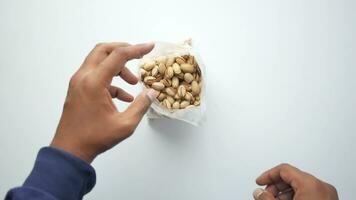 top view of pistachios nuts on hand video