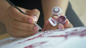 women hand holding brush with paint video