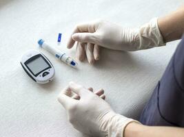 Close up shot of the glucometer instrument on the white surface. Healthcare photo