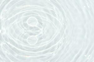 White water with ripples on the surface. Defocus blurred transparent white colored clear calm water surface texture with splashes and bubbles. Water. photo