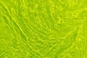 Green water waves on the surface ripple blurred. Defocus blurred transparent blue colored clear calm water surface texture with splash and bubbles. Water waves with shining pattern texture background. photo