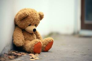 AI generated Lonely sorrow Childs teddy bear leans against wall, expressing sadness photo