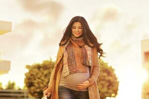 Beautiful pregnant woman with shopping bags photo