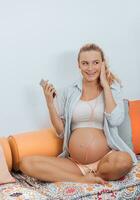 Pregnant Woman Listens Music photo