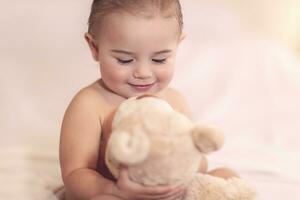 Cute baby with a bear photo