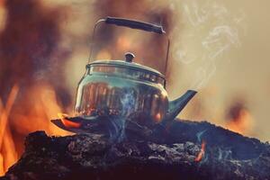 Steel Kettle on the Heat of Campfire photo