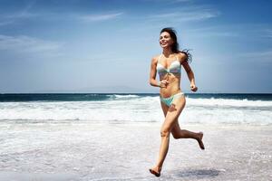 Woman running on a beach photo