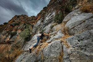 Woman Climbing the Cliffs photo