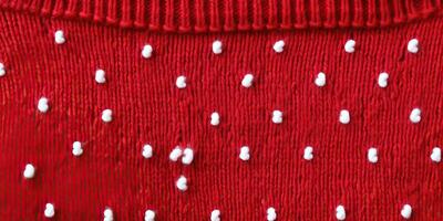 AI generated Wool sweater texture of red color with white dotted. Natural knitted wool dark red color material photo