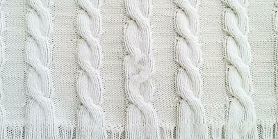 AI generated Wool sweater texture of white color with cable knitting stitch pattern. Natural knitted wool white photo