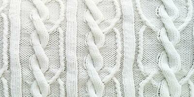 AI generated Wool sweater texture of white color with cable knitting stitch pattern. Natural knitted wool white photo