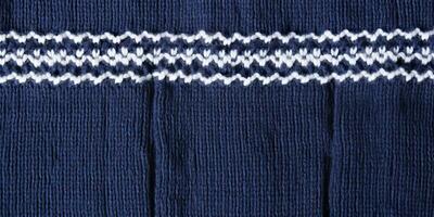 AI generated Wool sweater texture of dark blue color with white border. Natural knitted wool indigo color photo