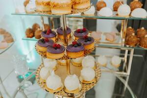 Candy bar with different sweets on white table against blurred background photo