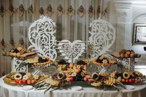 Candy bar. Table with sweets, candies, dessert. cakes and berries in the candy bar. Candy bar with delicious mini cakes, selective focus photo