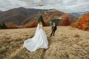 Young man on the hill of a mountain. Businessman. Bridegroom. Groom. Aerial photo