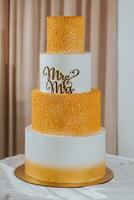 A wedding cake in a gray style, decorated with the letters Mr. and Mrs., stands on a stand. Decoration. Wedding. sweets photo