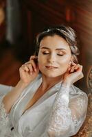 beautiful bride on a retro sofa in a dressing gown with open legs, photo portrait. Wedding hairstyle, light makeup
