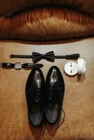 The morning of the groom and details, the details of the groom are dark. men's watch, wedding rings, men's bow tie photo