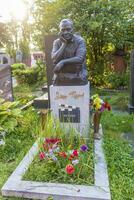 Moscow, Russia - 08.06.2023 - Memorial to the famous soviet russian film maker Eldar Ryazanov at novodevichy cemetery. History photo