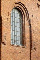 old window in a brick wall of an industrial nearly 100 years old buiding photo