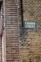 brick wall with old street sign photo